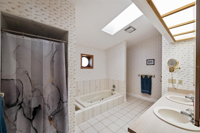 bathroom with tile patterned flooring, vanity, a skylight, and separate shower and tub