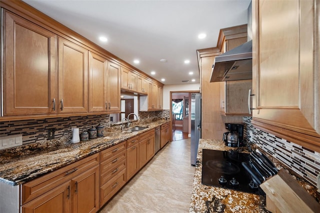 kitchen with sink, tasteful backsplash, dark stone counters, extractor fan, and appliances with stainless steel finishes