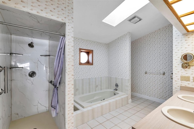 bathroom featuring tile patterned flooring, plus walk in shower, vanity, and a skylight