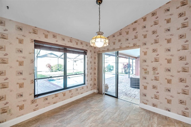 spare room with a healthy amount of sunlight and lofted ceiling