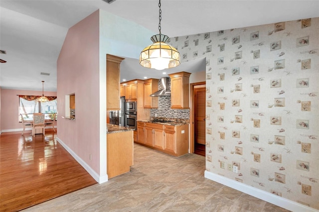 kitchen featuring pendant lighting, tasteful backsplash, black electric cooktop, dark stone counters, and wall chimney exhaust hood