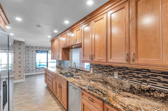 kitchen featuring sink, decorative backsplash, stainless steel dishwasher, and stone counters