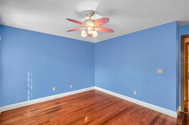 unfurnished room with ceiling fan, hardwood / wood-style floors, and a textured ceiling