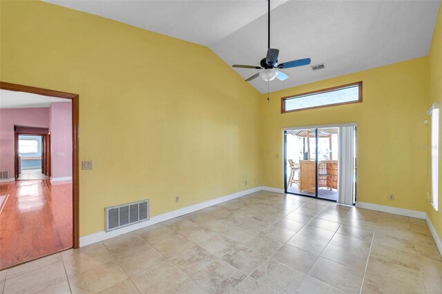 tiled empty room featuring high vaulted ceiling, a wealth of natural light, and ceiling fan