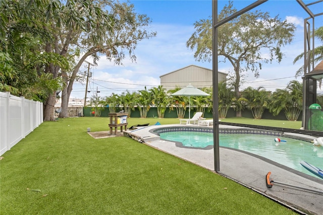 view of pool with glass enclosure, a yard, and a patio