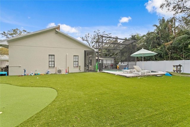 back of house featuring a fenced in pool, glass enclosure, ac unit, a patio, and a lawn