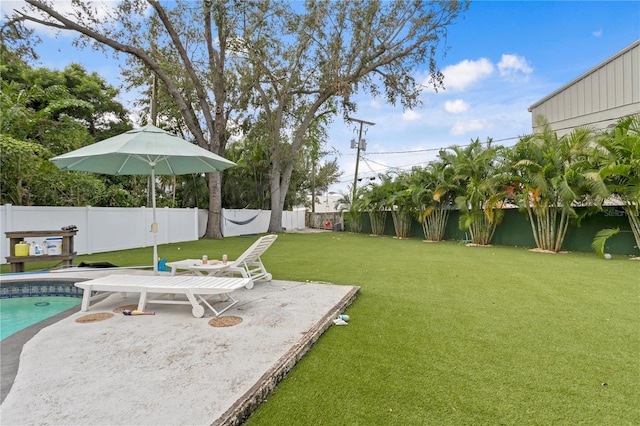 view of yard featuring a fenced in pool and a patio