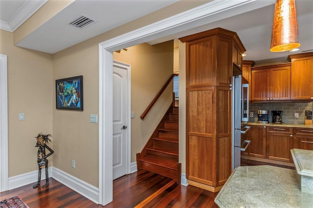 kitchen with dark hardwood / wood-style floors, crown molding, and decorative backsplash