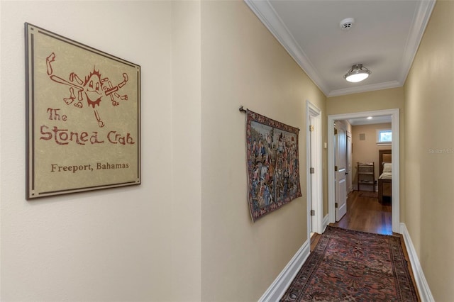 corridor featuring hardwood / wood-style flooring and ornamental molding