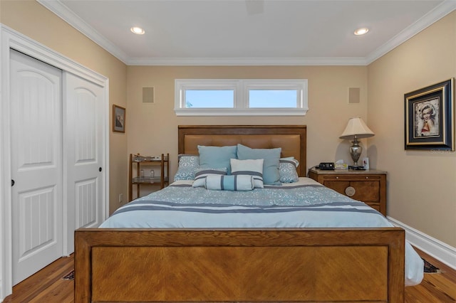 bedroom featuring a closet, hardwood / wood-style floors, and ornamental molding