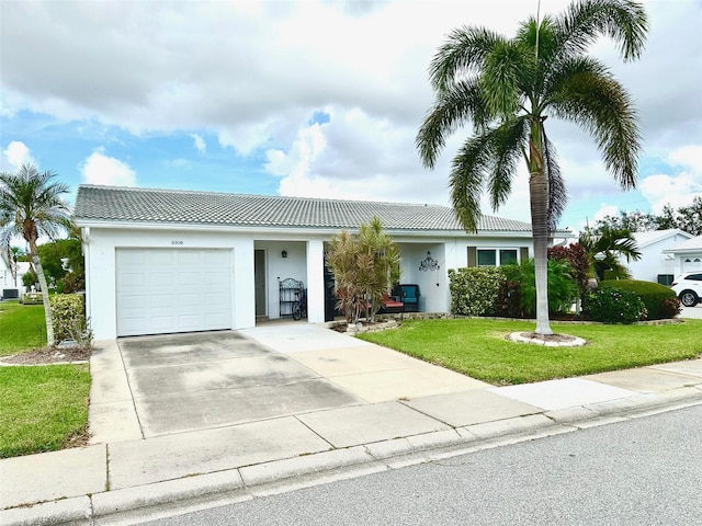 view of front of house featuring a front lawn and a garage