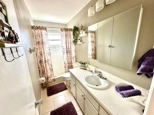 bathroom with walk in shower, vanity, toilet, and tile patterned floors