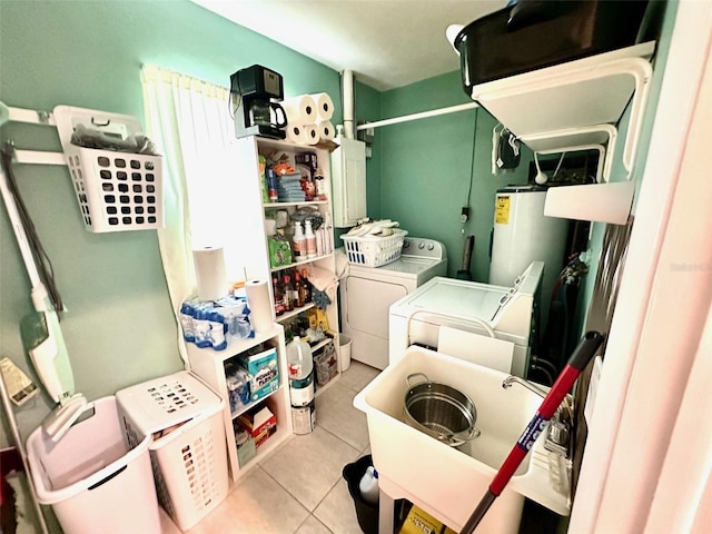 clothes washing area with water heater, washer and clothes dryer, sink, and light tile patterned floors