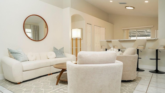 tiled living room featuring lofted ceiling