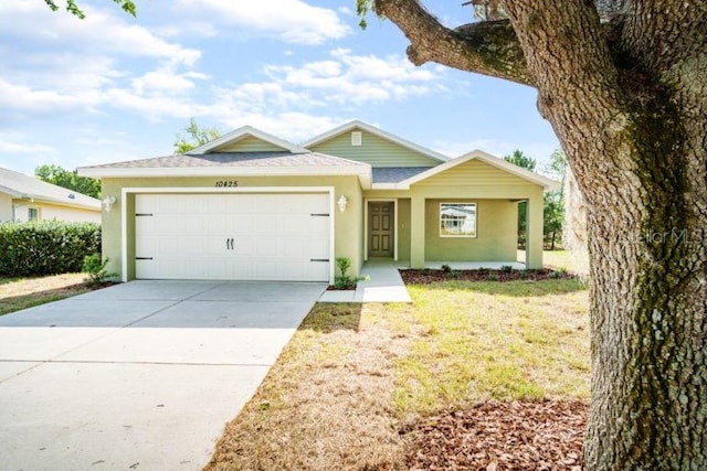 ranch-style house with a garage and a front yard