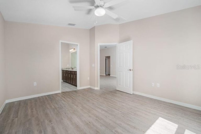 empty room with light wood-type flooring, lofted ceiling, and ceiling fan