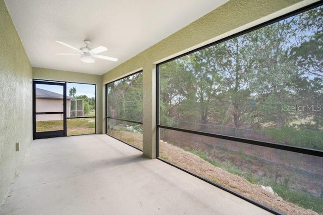 unfurnished sunroom with ceiling fan