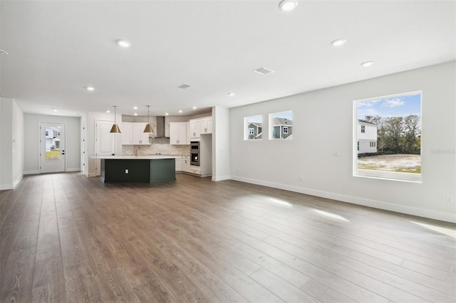 unfurnished living room featuring dark hardwood / wood-style flooring