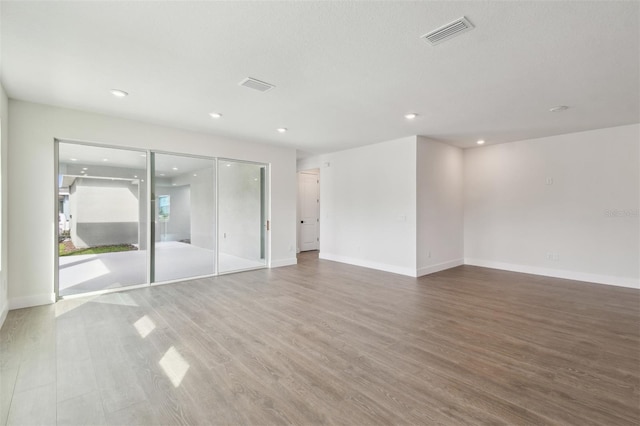 spare room featuring wood-type flooring