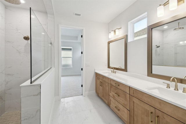 bathroom with vanity and tiled shower