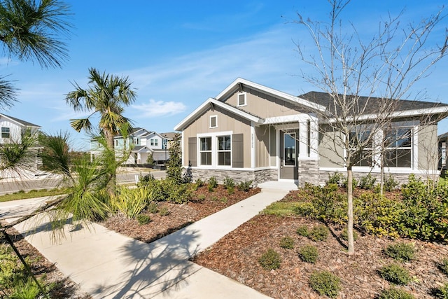 view of front of property featuring stone siding and board and batten siding