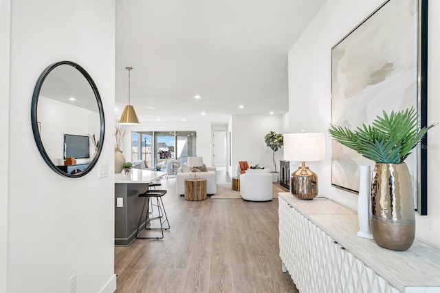 hall with light wood-style flooring and recessed lighting