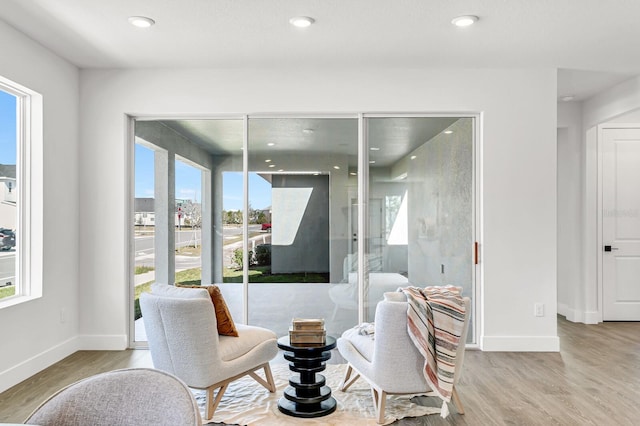 dining space featuring healthy amount of natural light, wood finished floors, baseboards, and recessed lighting