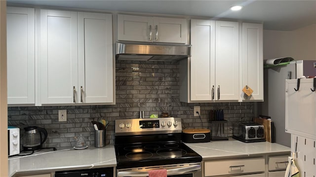 kitchen with stainless steel electric range, white cabinetry, light stone counters, and tasteful backsplash