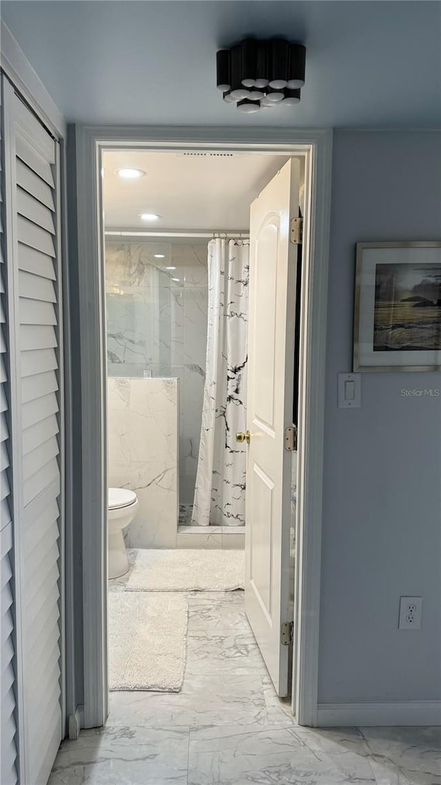 1243 S Martin Luther King Jr Ave Unit B205, Clearwater, FL 33756 - full bathroom with marble look tiles, toilet, and a marble finish shower