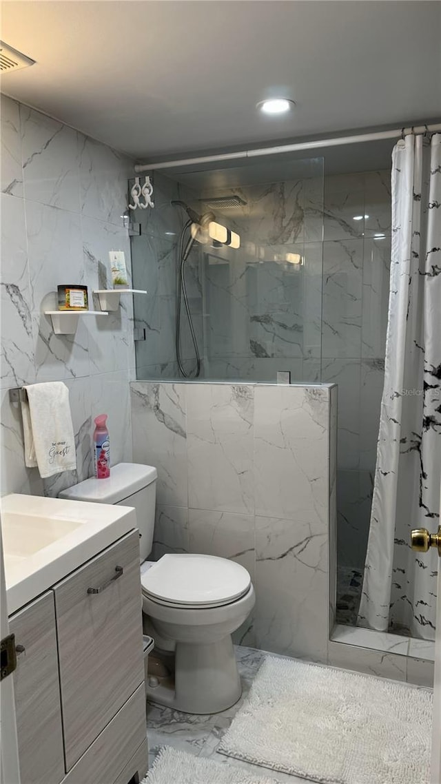 bathroom with a shower with shower curtain, vanity, toilet, and tile walls