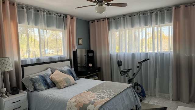 bedroom featuring multiple windows and ceiling fan