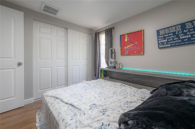 bedroom featuring light wood-type flooring and a closet