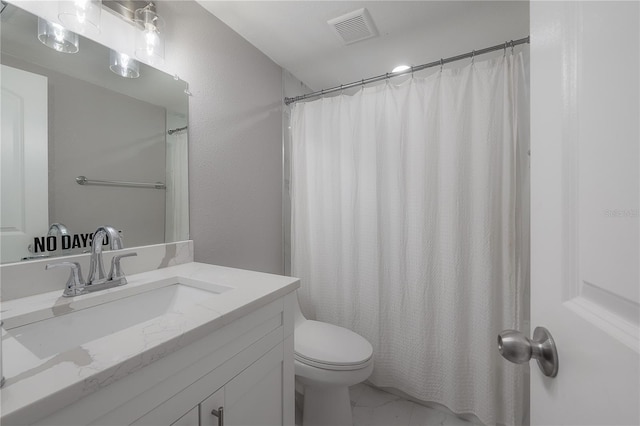 bathroom with toilet and vanity