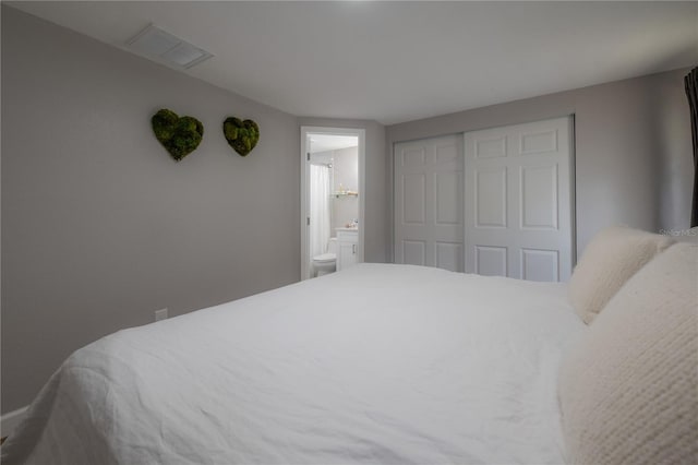 bedroom featuring a closet and ensuite bathroom