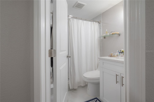 bathroom featuring curtained shower, vanity, and toilet