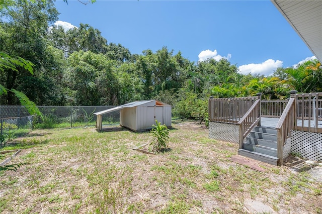 view of yard featuring a storage shed and a wooden deck