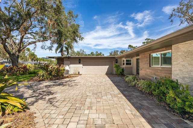 ranch-style home featuring a garage