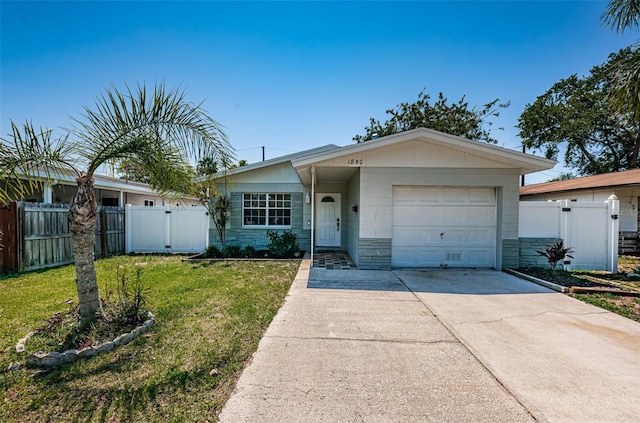 ranch-style house featuring a front lawn and a garage