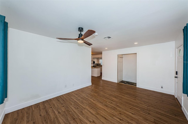 unfurnished living room with dark hardwood / wood-style flooring and ceiling fan