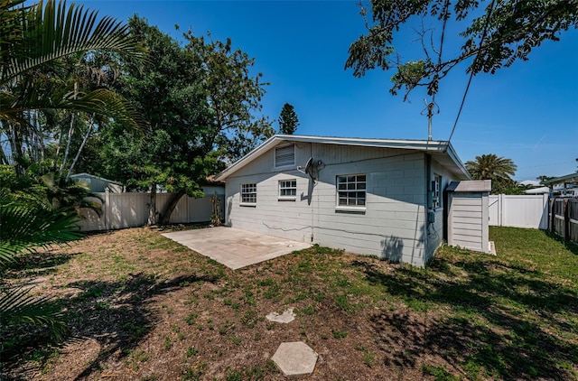 rear view of property with a patio and a yard