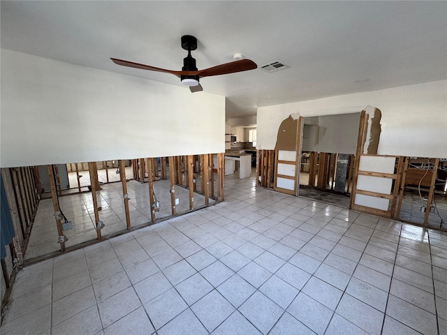 tiled empty room with ceiling fan