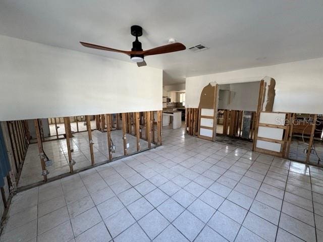 unfurnished room with ceiling fan and light tile patterned floors