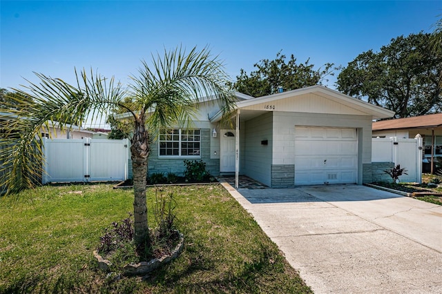 ranch-style house featuring a front lawn and a garage