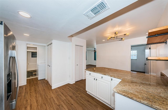 kitchen with white cabinetry, dark hardwood / wood-style flooring, stainless steel fridge with ice dispenser, and an inviting chandelier