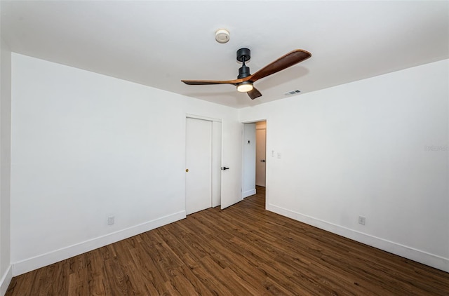 empty room featuring ceiling fan and dark hardwood / wood-style floors