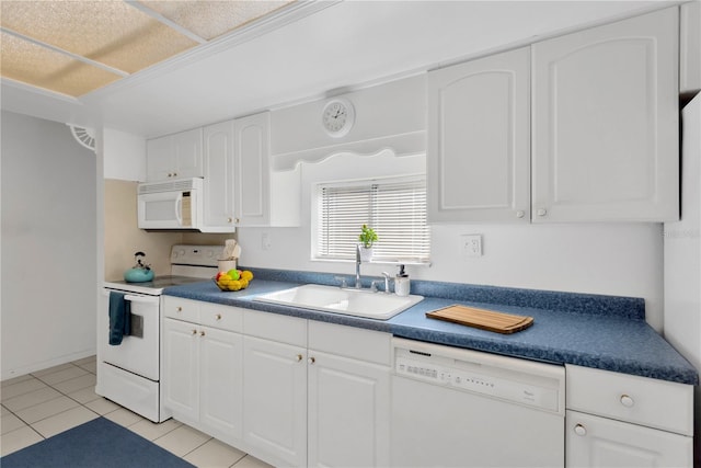 kitchen featuring sink, white cabinets, white appliances, and light tile patterned floors