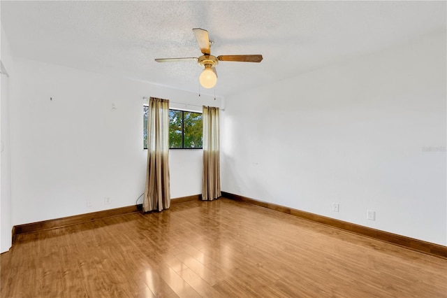 unfurnished room with a textured ceiling, hardwood / wood-style flooring, and ceiling fan