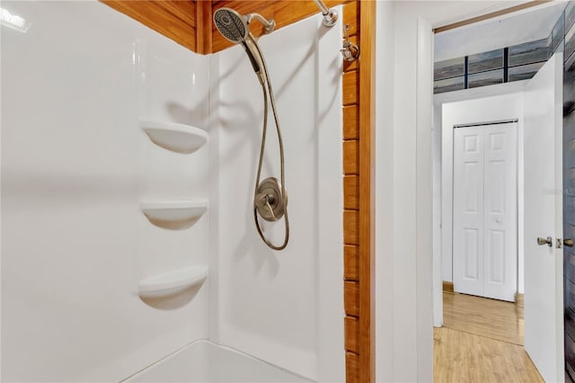 bathroom with wood-type flooring and a shower