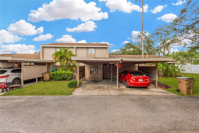 view of front facade featuring a front lawn and a carport