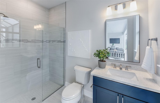 bathroom featuring toilet, vanity, and a shower with shower door